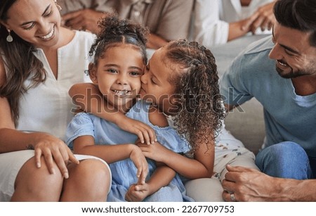 Sibling love, family and kiss with children sharing a special sister bond while at home with mom and dad for bonding and to relax. Happy latino girl kids or friends sitting with man and dad parents