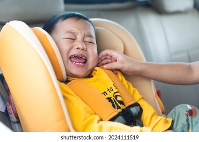 Sibling Relationship. Brother Teasing Little Baby Boy In The Car, Hitting His Ears Till He Screams And Cry. Toddler Sibling Kids' Child Prank In The Car.Childhood Problem.Conflict Fight With A Sibling