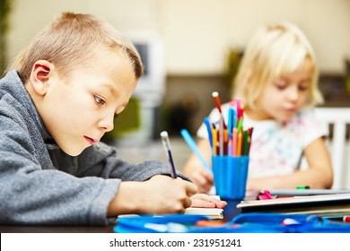 Siblings are doing his homework for elementary school.