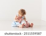 Siblings meet newborn baby. Child holding new infant brother for the first time. Kids visit mother in labor and delivery ward after birth of new baby. Sibling love. Family bonding.