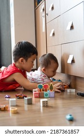 Siblings Playing And Sharing Together With Their Toys