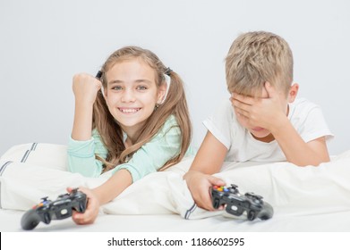 Siblings Playing Video Game In The Living Room, Sad Boy Lose, Girl Won And Rejoiced