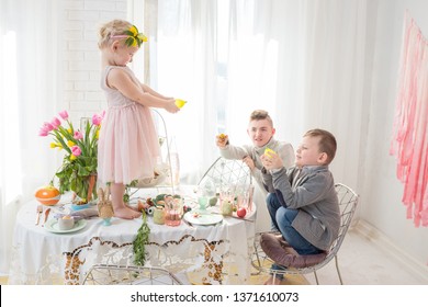 Siblings Playing With Water On Dyngus Day On Easter Monday In Poland.