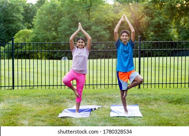 Siblings Practicing Yoga Outdoors in the Morning