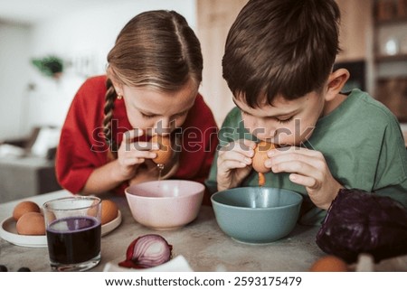 Siblings preparing egshells for easter egg decorating.
