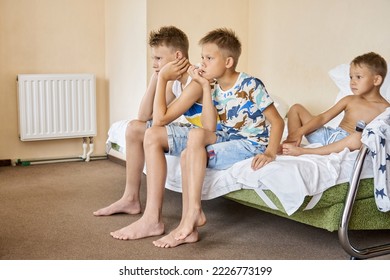 Siblings sitting on double bed watch movies on television - Shutterstock ID 2226773199