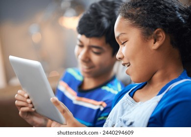 Siblings, tablet and happy with smile on couch, family home and technology for streaming and playing entertainment. Internet, children together and elearning for child development or online games - Powered by Shutterstock