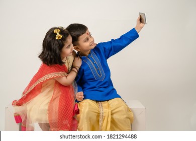 Siblings in tradional dress taking selfie