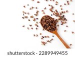 Sichuan pepper and wooden spoon set against a white background. Sichuan pepper is a member of the sansho family used in Chinese cuisine. View from above.