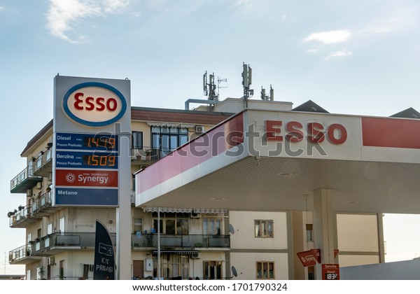 SICILY - FEBRUARY 14, 2020: The Esso gas station\
with a white banner where the gasoline and diesel fuels are sold at\
advertised price