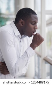 Sick African Man Coughing; Portrait Of Ill Black Man Cough Due To Cold, Flu, Allergy, Polluted Air, Fine Dust, Tuberculosis; Air Pollution, Lung Cancer, Emphysema Concept; African Man Model