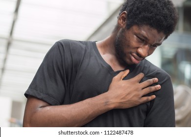 Sick African Man With Heart Attack Or Chest Pain; Portrait Of African Man Suffering From Heart Attack, Chest Pain, Health Care Concept; Young Adult African Man Or Black Man Model