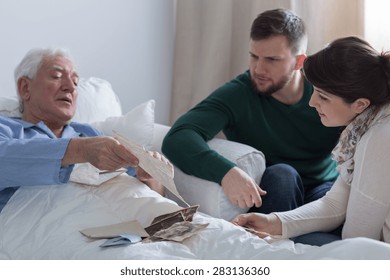 Sick Aged Man Showing Old Letter To His Kids