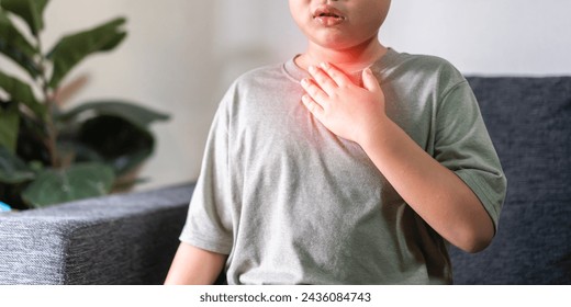 Sick asian boy touching neck unwell coughing with sore throat pain,lung cancer,bronchitis,Bronchial Asthma,Tuberculosis,pneumonia,covid-19,eco air pollution pm2.5.insurance and hospital - Powered by Shutterstock