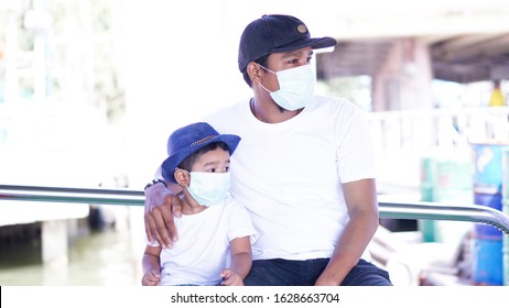 Sick Asian Kid 2 Year Old Wearing The Surgical Mask To Protect The Germ Or Virus From The Air.2019-Corona Virus Very Dangerous. Father Holding Son Asian Family Feeling Feeling Sad Worry.              