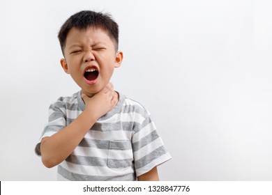 Sick Asian Kid Touching His Painful Neck, Sore Throat And Flu, Throat Infection. Isolated On White Background.