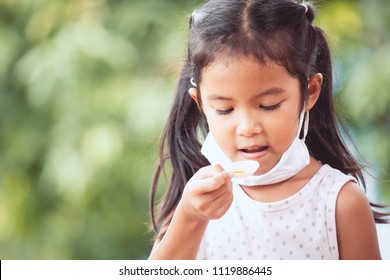 Sick Asian Little Child Girl Wear Protective Mask Was Taking Syrup Medicine