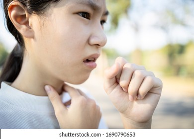 Sick Asian Woman Has A Chronic Cough With Tonsillitis,ill Child Girl Touch The Neck With Fever,acute Cough,sore Throat Pain Irritation,voice Is Hoarse From Cold,influenza, Respiratory Tract Infection