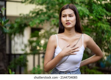 Sick Asian Woman Having Breast Related Disease, Acid Reflux, Sore Throat Or Pharynx Allergy