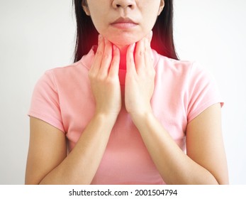 Sick asian woman with sore throat  on white background. closeup photo, blurred.