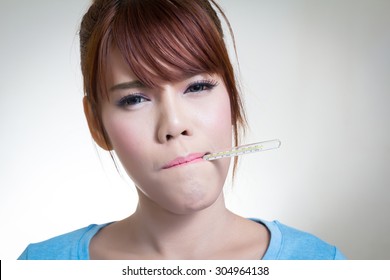 Sick Asian Women With Thermometer In Mouth 