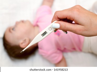 Sick Baby Being Checked For Illness And Fever.