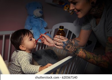 Sick Baby Being Tended By Parent 