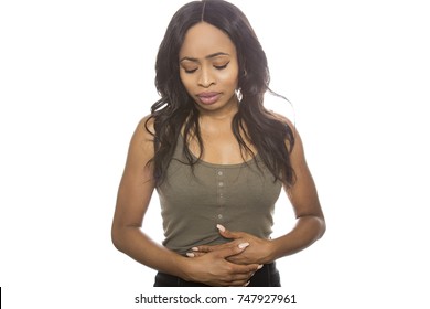 Sick Black Female Isolated On A White Background With Stomach Ache.  She Is Young And Of African American Ethnicity.