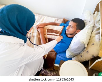 Sick Boy Being Checked By Muslim Female Doctor