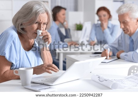 Sick business woman working in modern light office