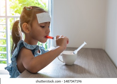 Sick Child., Asian Kid Girl Eating Medication Or Cough Syrup By Syringe. , Health And Medical Concept.