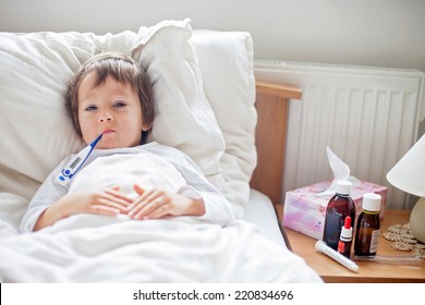 Sick Child Boy Lying In Bed With A Fever, Resting