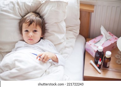 Sick Child Boy Lying In Bed With A Fever, Resting