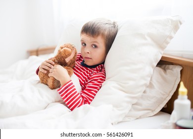 Sick Child Boy Lying In Bed With A Fever, Holding Terry Bear With Band Aid, Resting