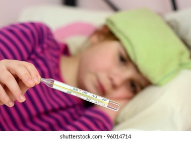 Sick Child Girl Showing Big Fever On Thermometer