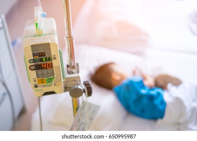 Sick Child Lying In A Hospital With IV In The Hospital With Saline Intravenous