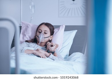 Sick Child With Oxygen Mask During Treatment In The Hospital