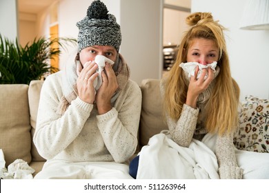 Sick couple catch cold. Man and woman sneezing, coughing. People got flu, having runny nose. - Shutterstock ID 511263964
