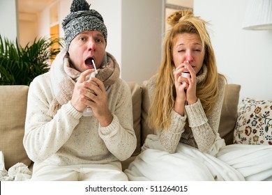 Sick couple catch cold. Man and woman sneezing, coughing, got flu, having runny nose. People spraying medication into nose and throat.  - Shutterstock ID 511264015