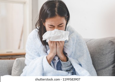 Sick day at home. Asian woman has runny and common cold. - Shutterstock ID 1199583907