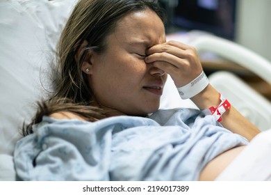 Sick depressed patient laying in bed in the hospital. Health problems and miscarriage. 