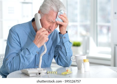 Sick elderly man calling by phone - Powered by Shutterstock