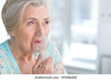 Sick elderly woman making inhalation - Powered by Shutterstock