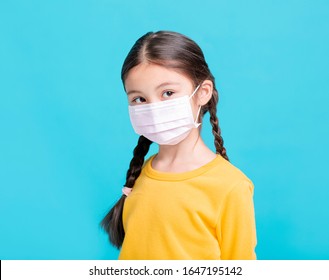 Sick Girl Child In Medical Mask Isolated On Blue Background