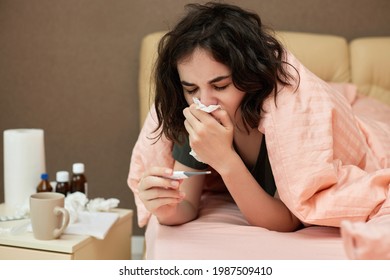 sick girl having influenza symptoms coughing at home - Powered by Shutterstock