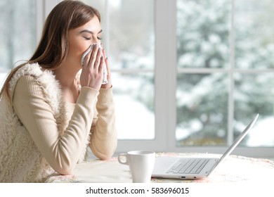 Sick girl with laptop - Shutterstock ID 583696015