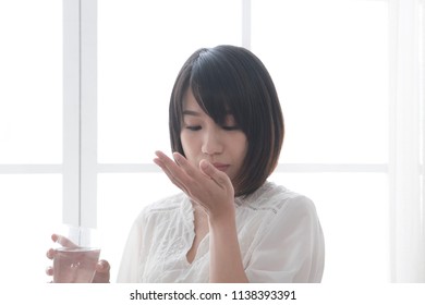Sick girl taking medicine - Shutterstock ID 1138393391