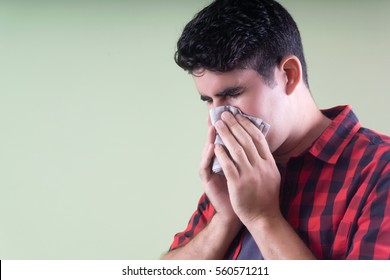 Sick hispanic man sneeze
