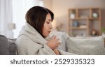 Sick, home and tea of woman with cold, flu and illness with blanket for wellness and health problem on sofa. Living room, coffee and hot drink with covid virus or allergy with rest and mug to relax