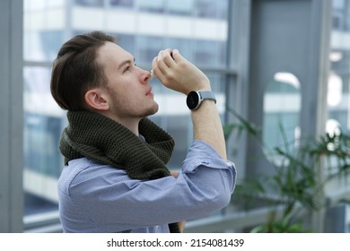 Sick Ill Guy, Young Man Drips, Injecting Nasal Drop For Blocked Nose Boy With Runny Nose Holds Medicine Spray, Pills In Hand At Business Office. Illness Sickness. Sinusitis Treatment. Cold In The Head